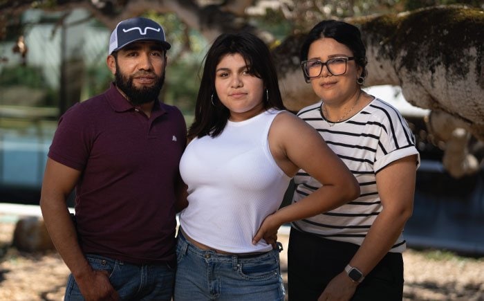 A daughter posting with mother and father