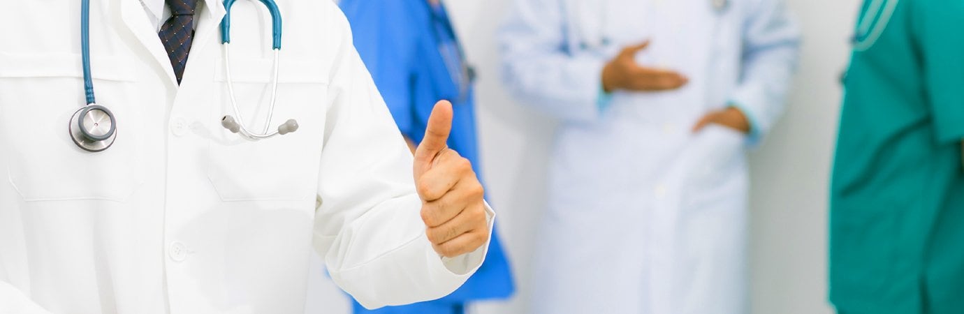 medical professional giving a thumbs up