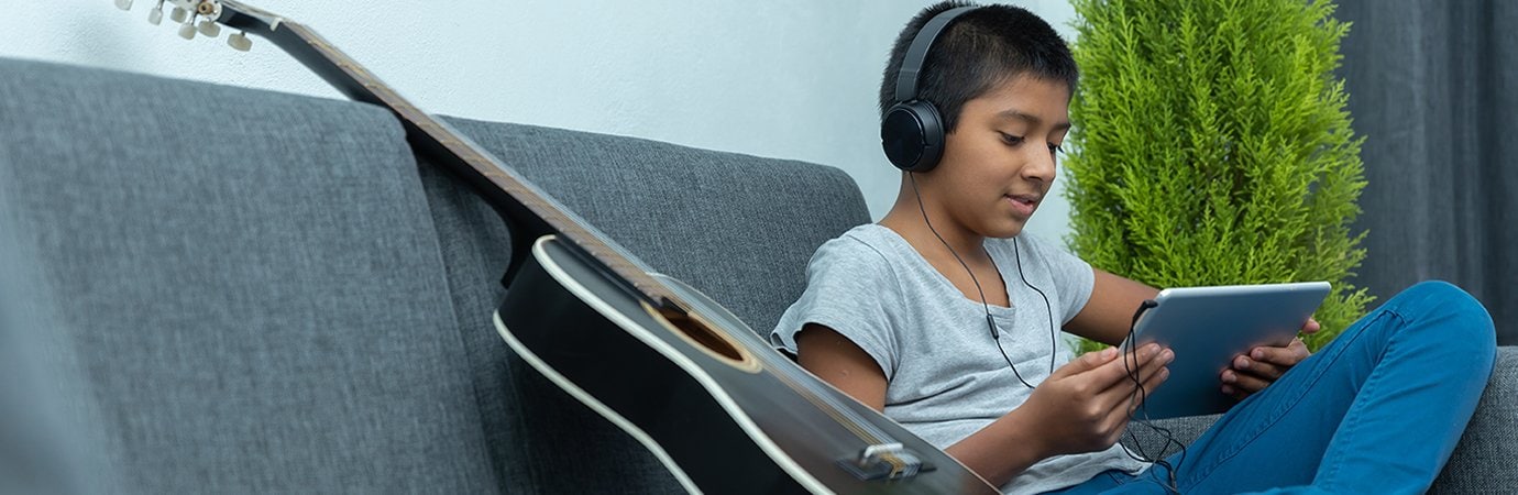 Teen with Tablet and Guitar