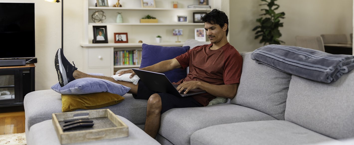 Man icing his knee at home