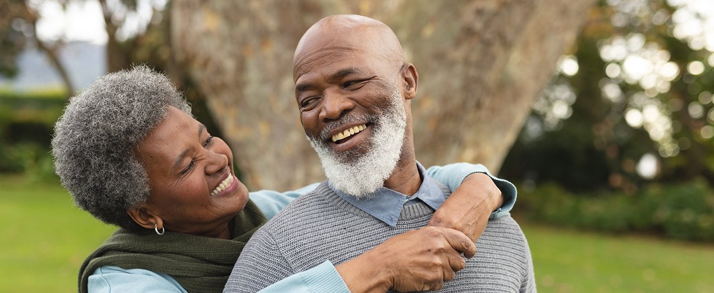 Woman with her arms around her husband