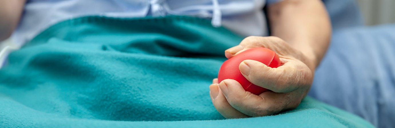 Man using a stress ball for strength building