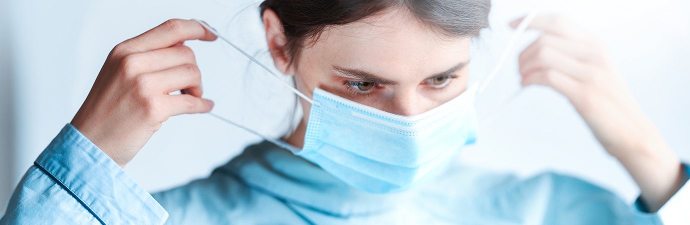 woman putting on a mask