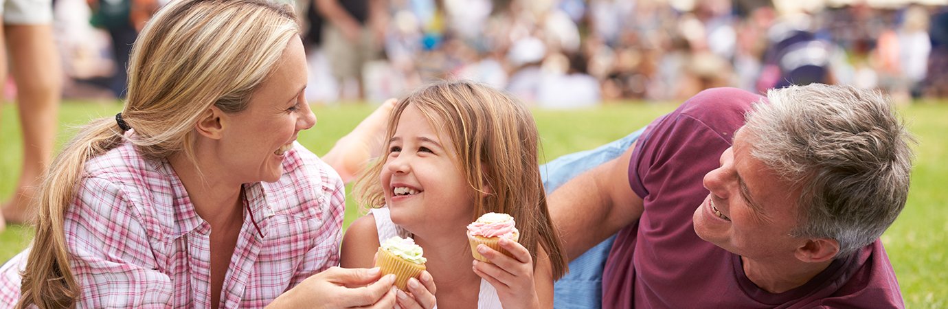 family of three eating cupcakes