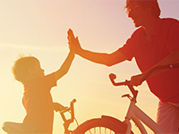 Dad and son riding bikes