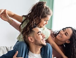 Mom, and daughter, on dad's shoulders