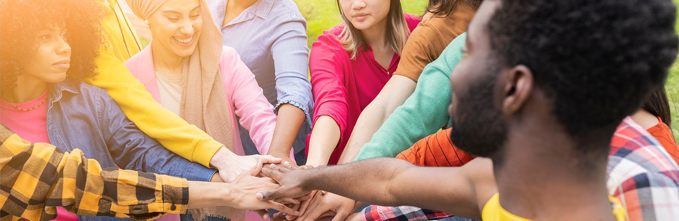 Adults putting hands in during huddle