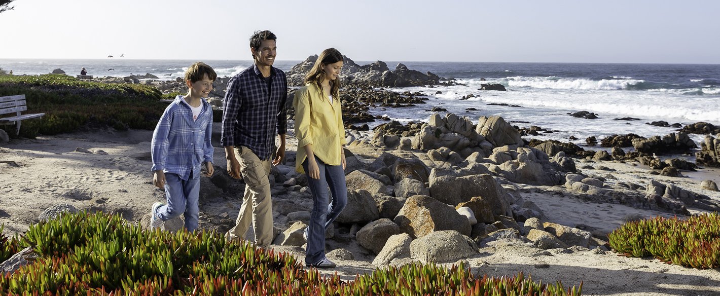 Father and his children walking on beach